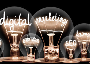 Photo of light bulbs with shining fibers in a shape of Digital Marketing, Website, SEO and Strategy concept related words isolated on black background